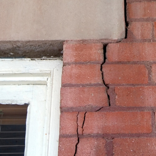 Cracked basement foundation starting at a corner of a window